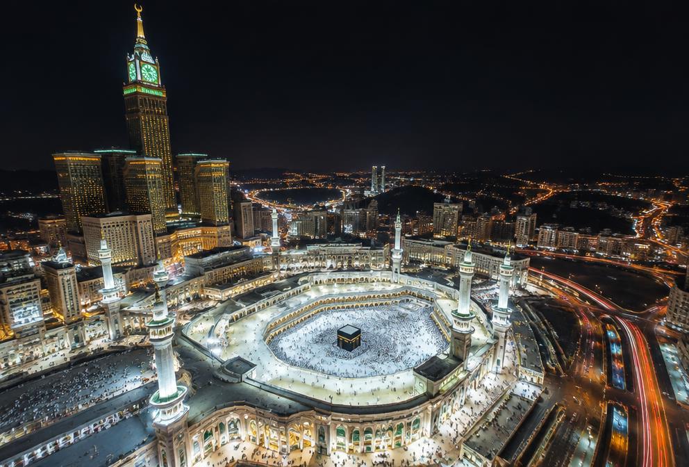 Aerial night view of the glowing Masjid al-Haram in Makkah